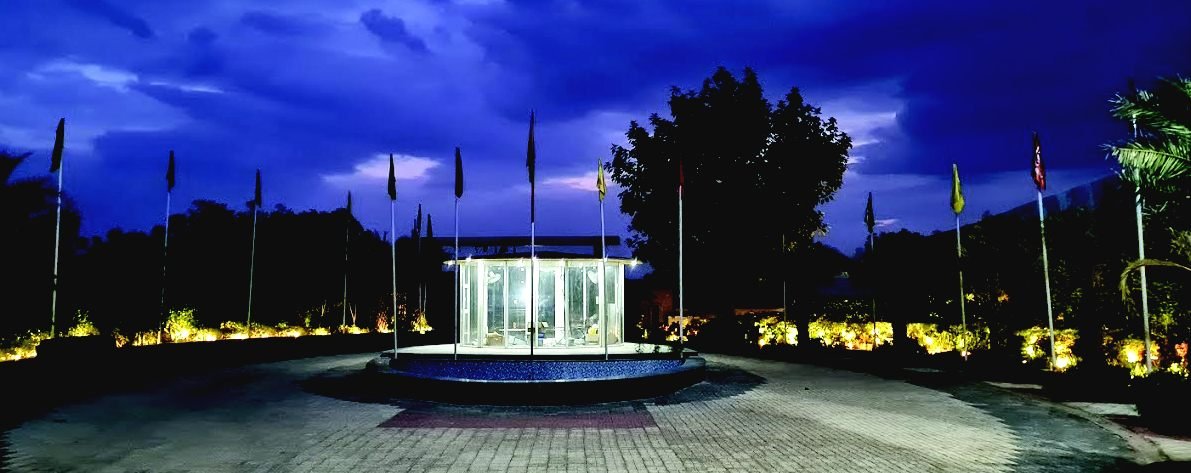 Landscaped entrance boulevard with gazebo and flag posts at NKV Golden Avenue